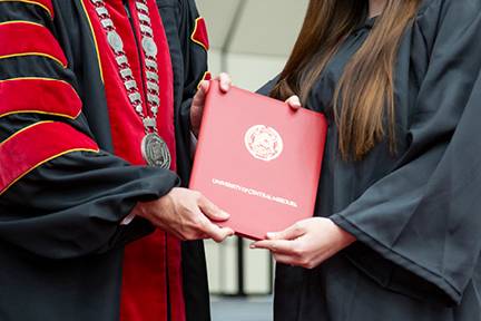 A graduating student receiving their diploma