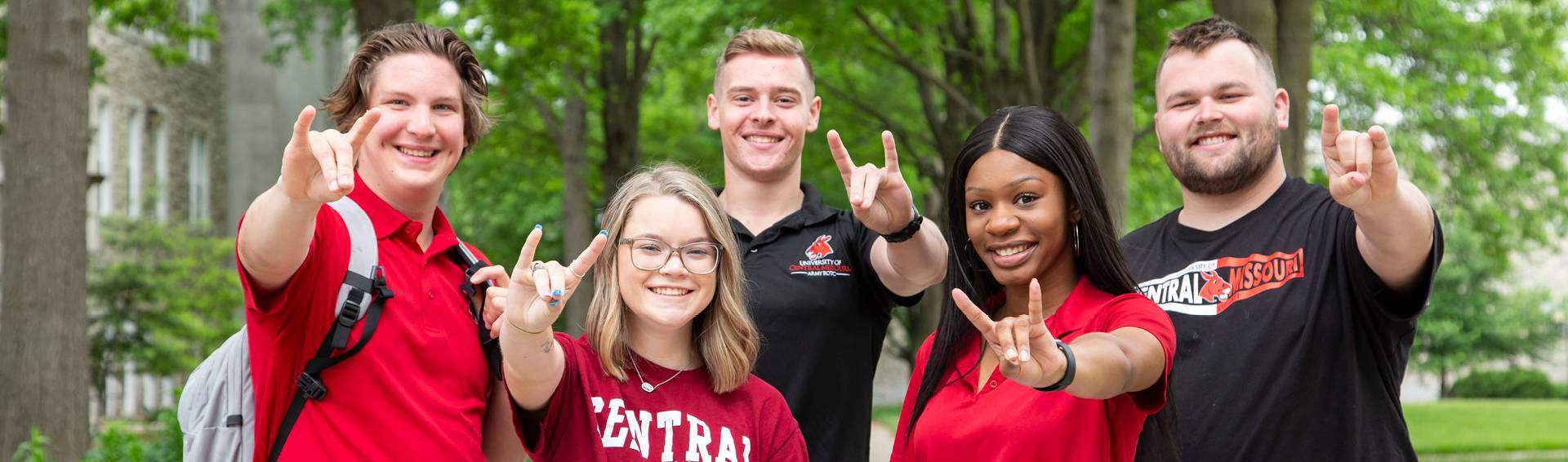 UCM students giving the "snouts out" hand signal