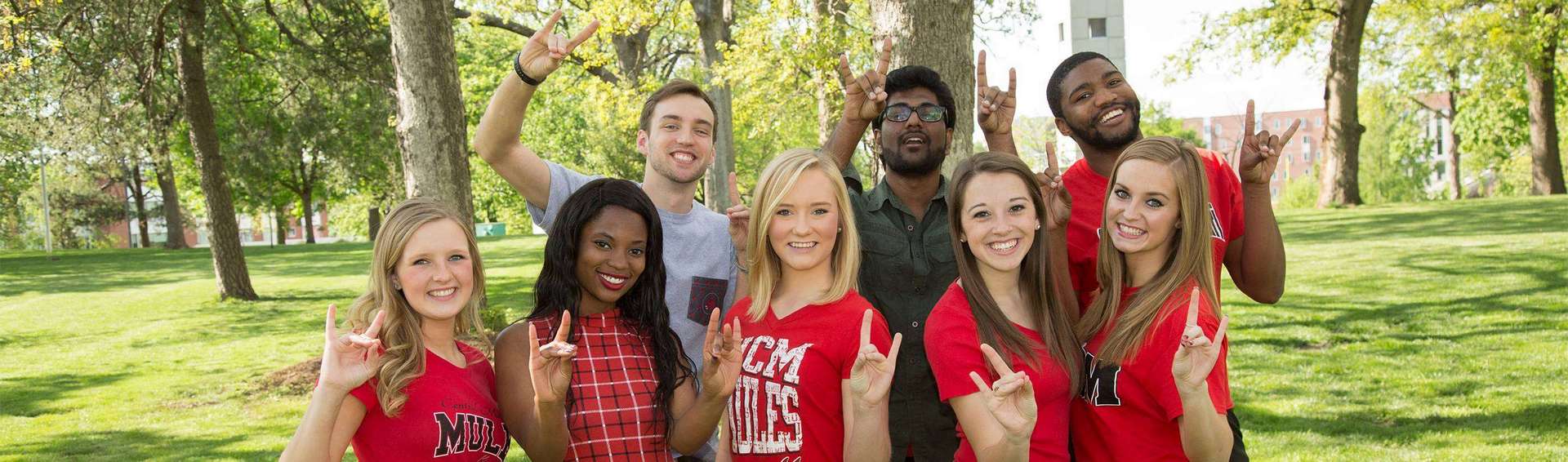 Students make the "snouts out" hand signal